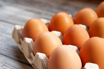 brown chicken eggs on a light wooden background