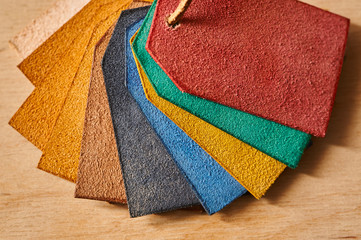 Leather shreds of different colors close-up. Theme of painting leather and leather products