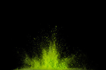 green powder explosion isolated on black background