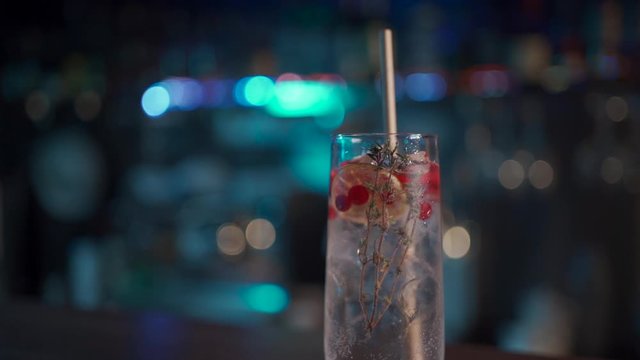 bartender mixing modern gin tonic cocktail with ice