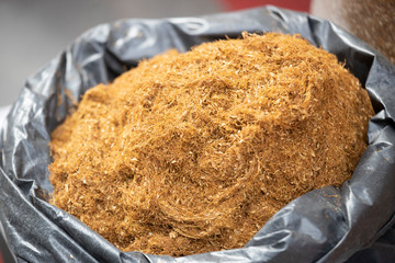 Dried tobacco sold in bags in the street. Photographed in Turkey. Various tobaccos side by side. Close up.