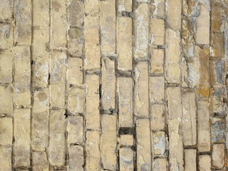 old brick wall of yellow brick and with cracks