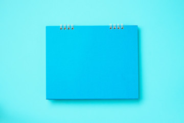 Empty blank calendar on blue background