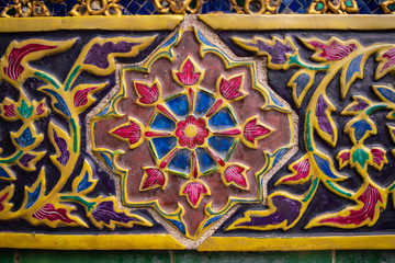 Close up of colorful thai ceramic, wall decoration of Palace in Bangkok