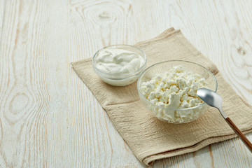 Glass bowls with fresh village cottage cheese and yogurt.  Healthy food.  Dairy product.