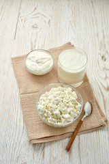Glass bowls with fresh village cottage cheese and sour cream, glass with yogurt.  Healthy food.  Dairy producst.