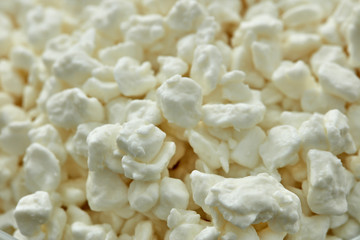 Background from fresh village cottage cheese. Close- up. Healthy food.  Dairy product.