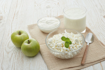 Still life with fresh village cottage cheese, sour cream, yogurt and two apples. Healthy food. Dairy producst. Healthy meal