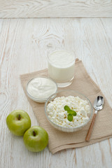 Still life with fresh village cottage cheese, sour cream, yogurt and two apples. Healthy food. Dairy producst. Healthy meal
