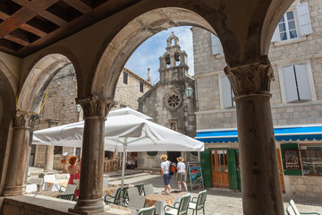View through the arches of old house to lively square in medieval Korcula in Dalmatia, Croatia