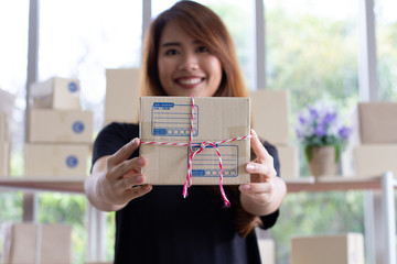 SME Business concept : girl with hand box packing sen to customer service, startup small business entrepreneur sme. © Namphung