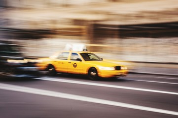 Fototapeta na wymiar Blurred Motion Of Yellow Car On Road