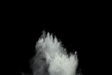 White powder explosion isolated on black background.