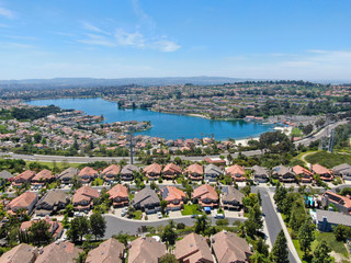 Aerial view of Lake Mission Viejo, with recreational facilities, surrounded by private residential and condominium communities. Orange County, California, USA