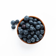 Blue berries in a wooden cup. Top View