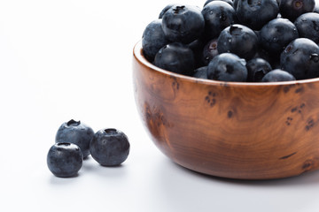 Fresh blue berries in a wooden cup