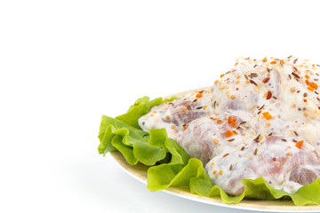 semi-finished product, home-made pork skewers on a white plate,