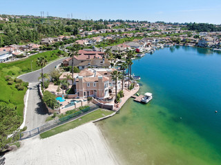 Fototapeta na wymiar Aerial view of Lake Mission Viejo, with recreational facilities and beach, surrounded by private residential and condominium communities. Orange County, California, USA