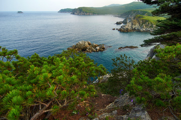 High cliffs in the ocean. Rocky islands and rocks in Orlik Bay in the Sea of Japan. Far East.