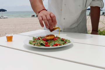 Chef spicing a salad in a restaurant
