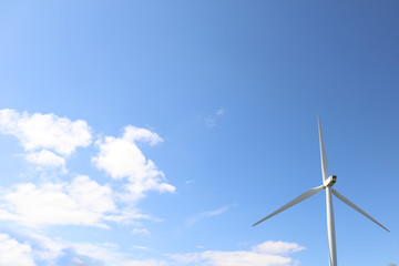 Windmill turbine with blue sky