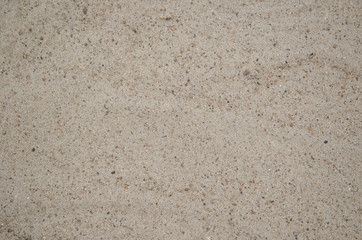 Sand and small stones. Wild beach. Natural background.