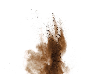 Explosion of brown powder on black background.