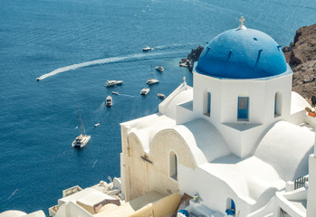 Fototapeta na wymiar White Church with blue dome at Oia, Santorini, Greek Islands