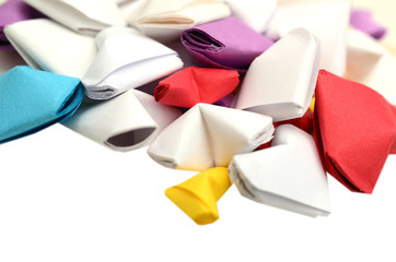Closeup of folding paper hearts on white