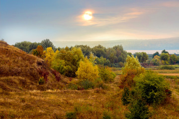 Picturesque autumn landscape with trees in the forest near the rocks