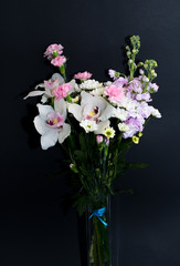 Spring bouquet of flowers in white and pink tones on a black background. Carnations. Flowers for mother's Day