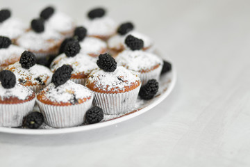 Plate with freshly baked sweet muffins. Sweet pastries, recipes, cooking