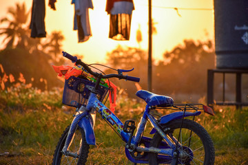 Fototapeta na wymiar child's bicycle with sunset