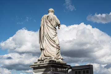 majestic statue against the blue sky with a cloud