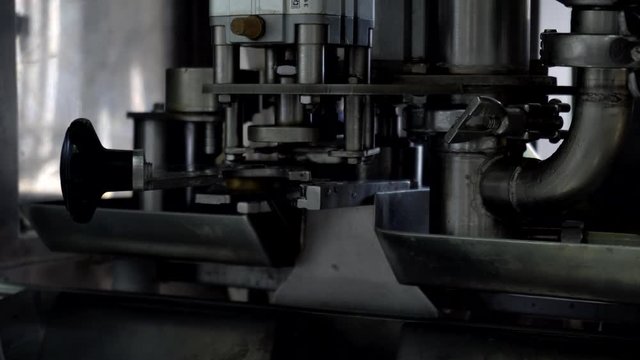 The automatic process of filling and bottling drinking yogurt and cream in the confectionery industry, industry, background. Technological process, production