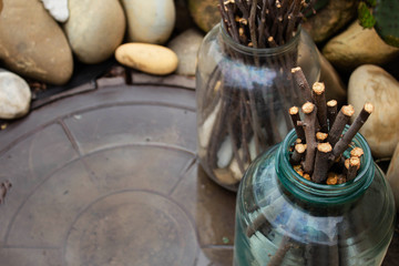 glass jars with branches and stones in the garden as a garden decoration. Place to copy