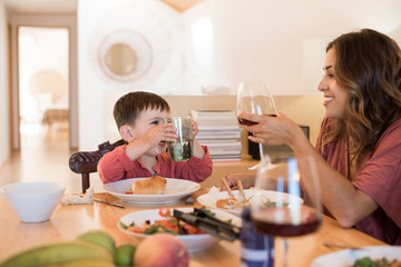 Young family with a little child sitting together for lunch
