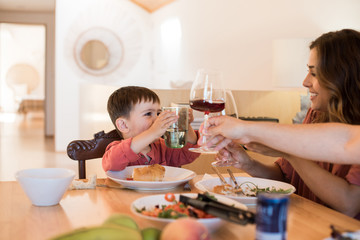 Young family with a little child sitting together for lunch