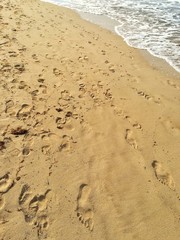 Fototapeta na wymiar Foodprints on the sand beach