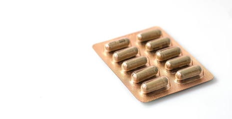 Panel of herbal medicines packaged in capsules on a green background.