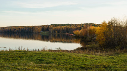Autumn evening on the shore of the pond