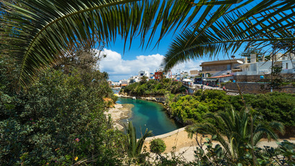 View of the Emerald Bay through palm leaves