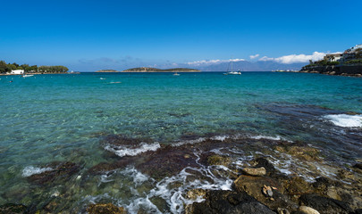 View of the bay, the island and the lonely yacht on a summer day