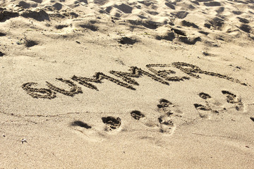 Summer. Sand beach. Text on the sand. Sea shore. Ocean