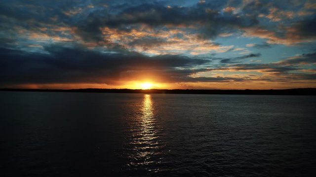 Gorgeous golden sunset on a large river at Alligator Beach near Joao Pessoa, Brazil