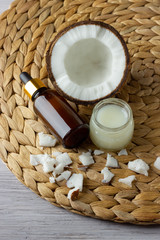 Coconut oil and fresh coconuts on the wooden table
