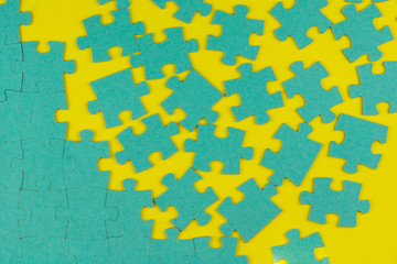 blue puzzle in disassembled form on a yellow background