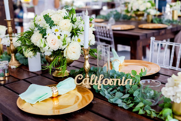 Wooden table board sign at the wedding on the beach with welcoming romantic words