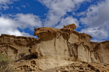 Eroded Volcanic ash and breccia rock deposits forming dramatic Cliffs in a nature Reserve in Tenerife.