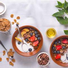 Health plate cereal with strawberries and yogurt on a white tablecloth